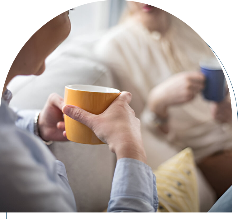 Two people are drinking coffee and talking.